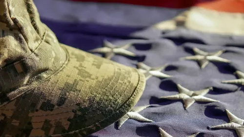 Military cap on flag.