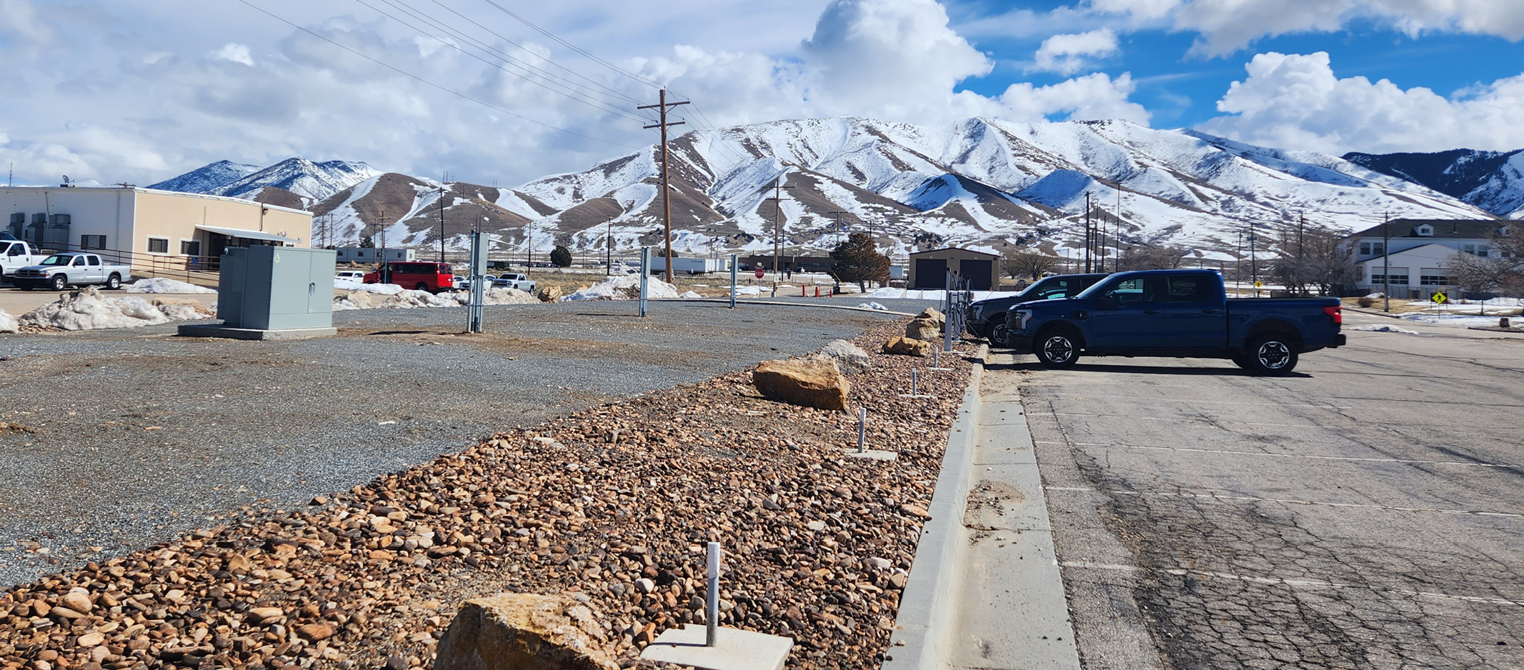 Two electric vehicles parked at a charging station.