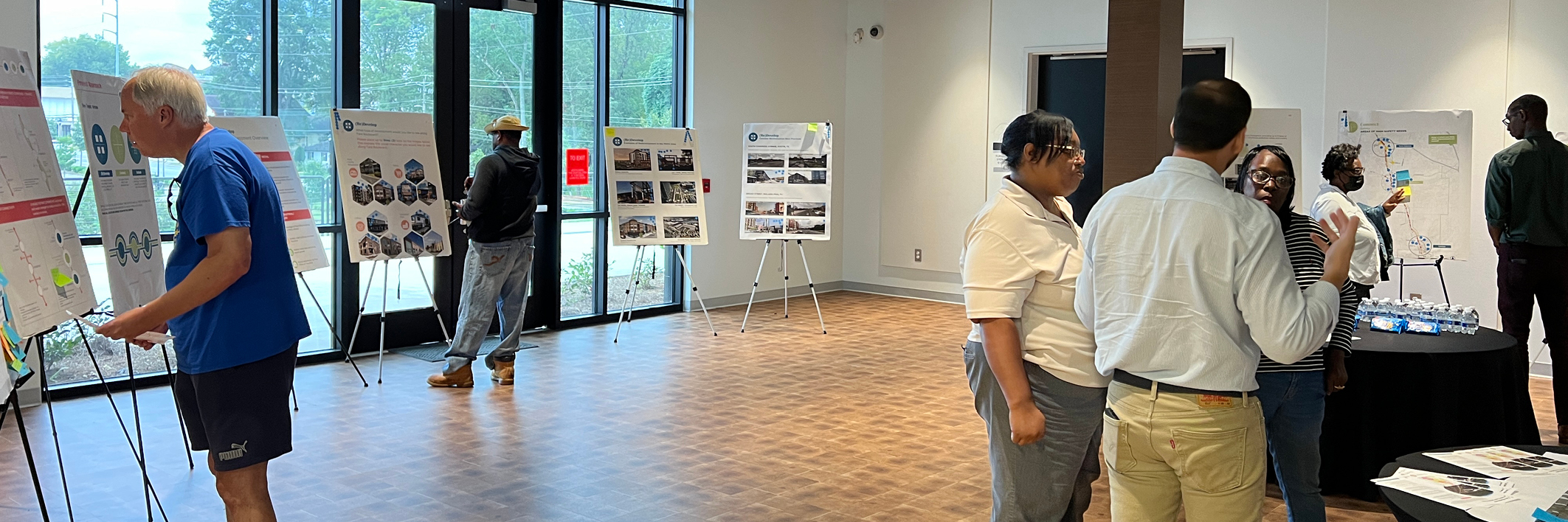 Several people participating in a community planning open house event.