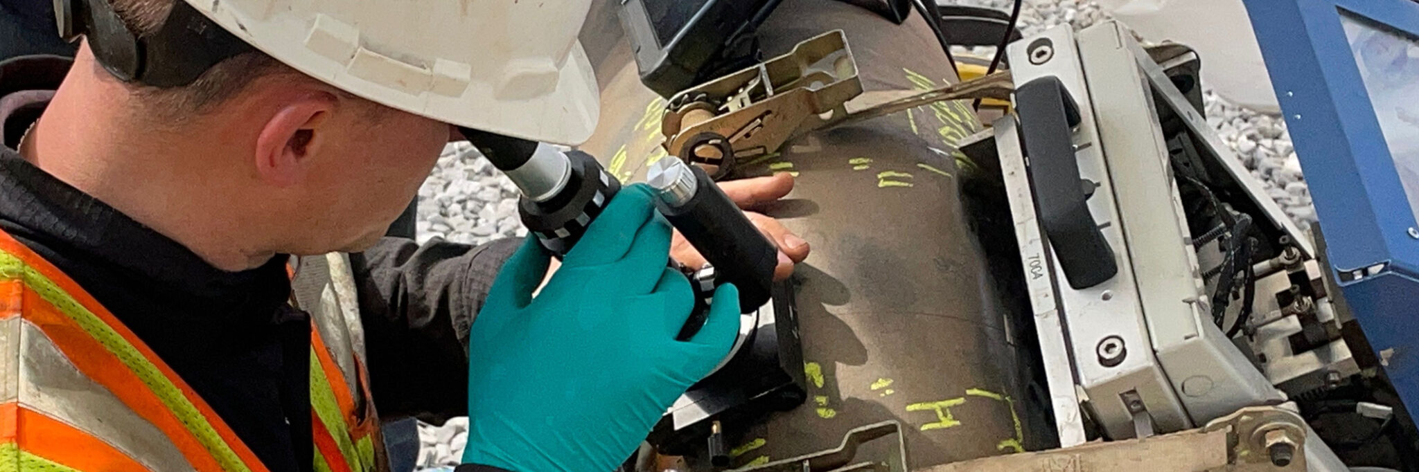 A man performing a pipeline inspection with a microscope.