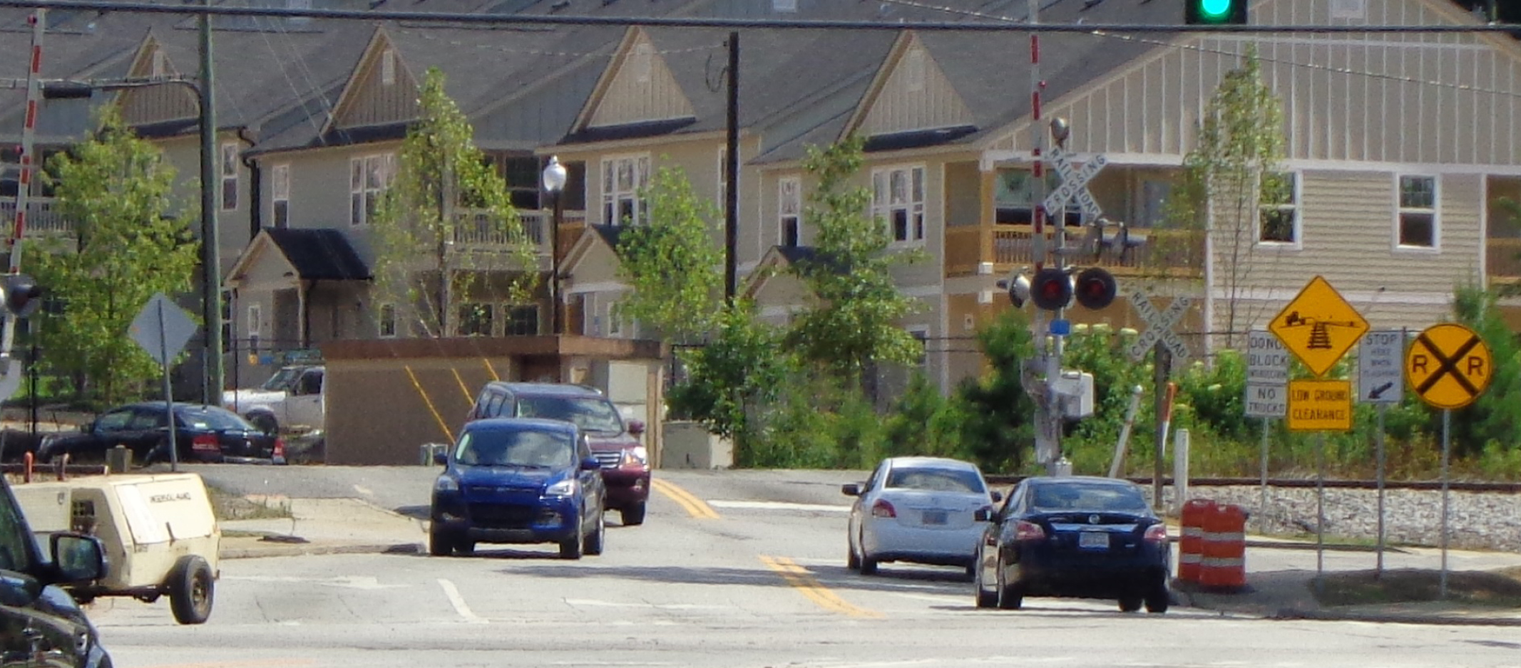 Four cars driving through an intersection.
