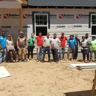 Pond employees gathering in front of a building