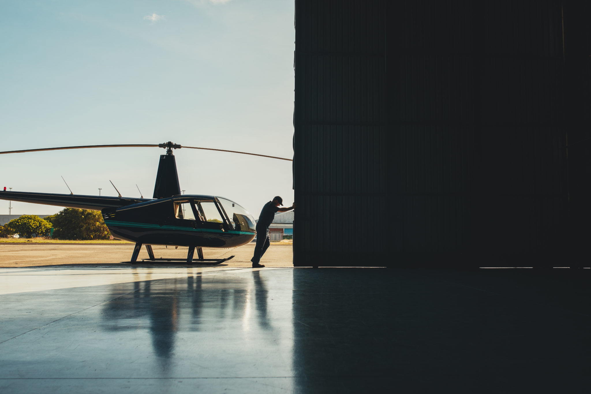 Pilot opening the helicopter hangar door